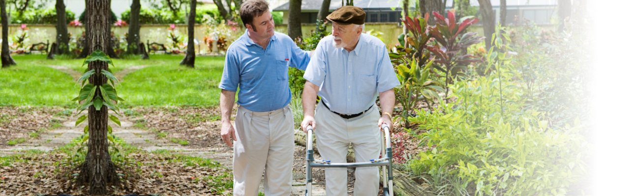 caregiver and old man strolling
